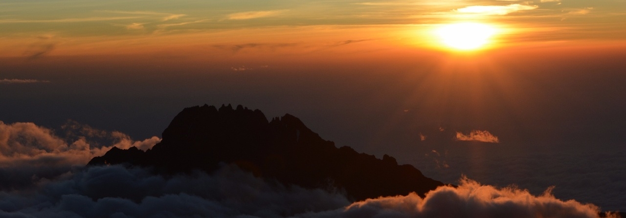 Kilimanjaro under a full moon. Climb Kilimanjaro to see the sunrise from Uhuru Peak